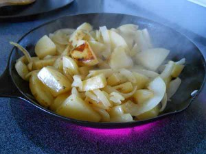 Taters and onions sautéing in the pan